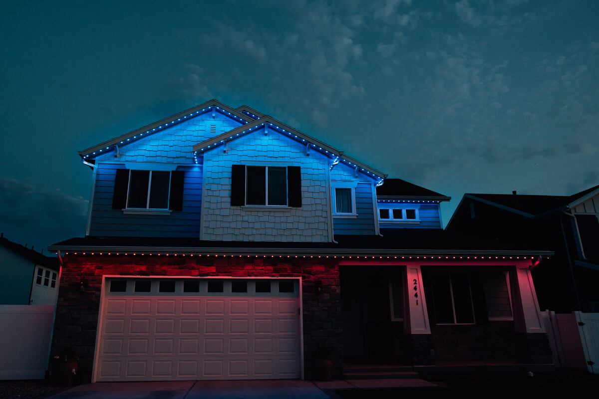 Home roofline lit blue on top and red on bottom in security mode