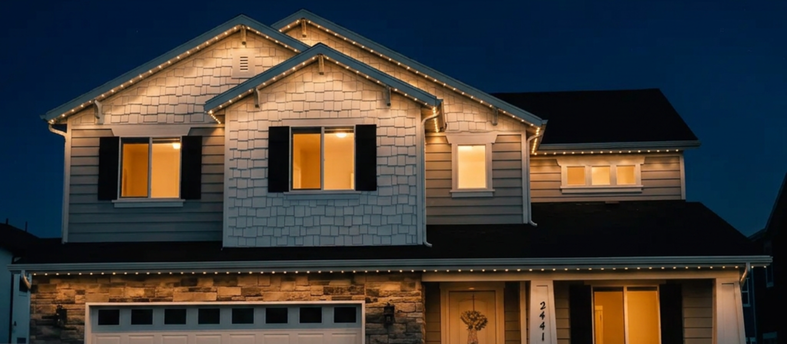 Utah home at night with permanent roofline lighting in warm white across every peak and eave