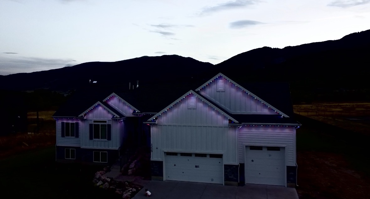 Home at dusk with subtle purple and blue lighting against a mountain backdrop