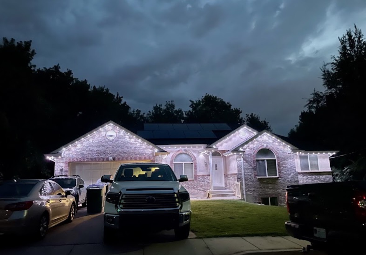 Brick rambler with crisp warm white roofline lighting