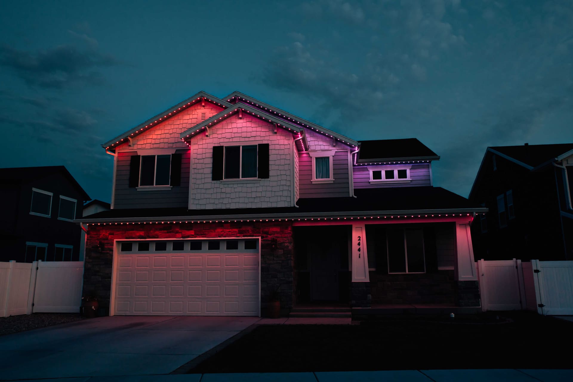 Pink craftsman home with permanent lighting