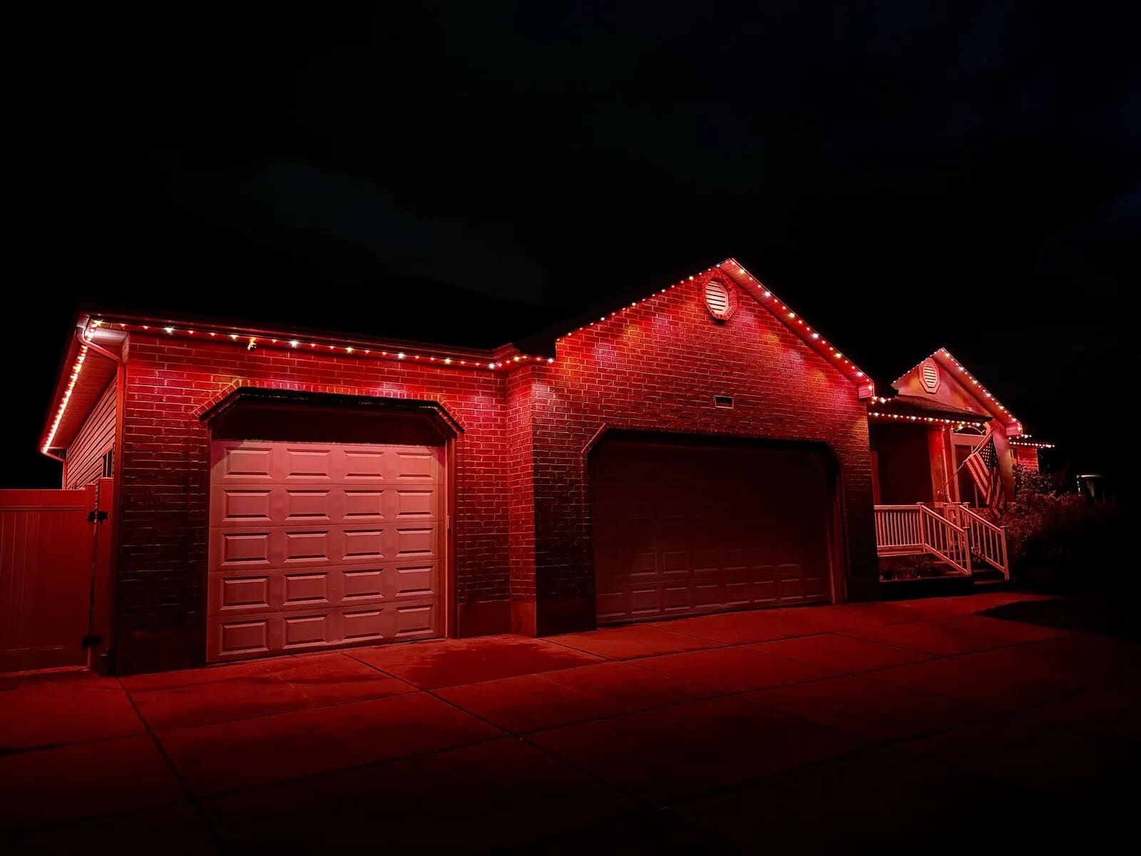 Red brick home with permanent lighting